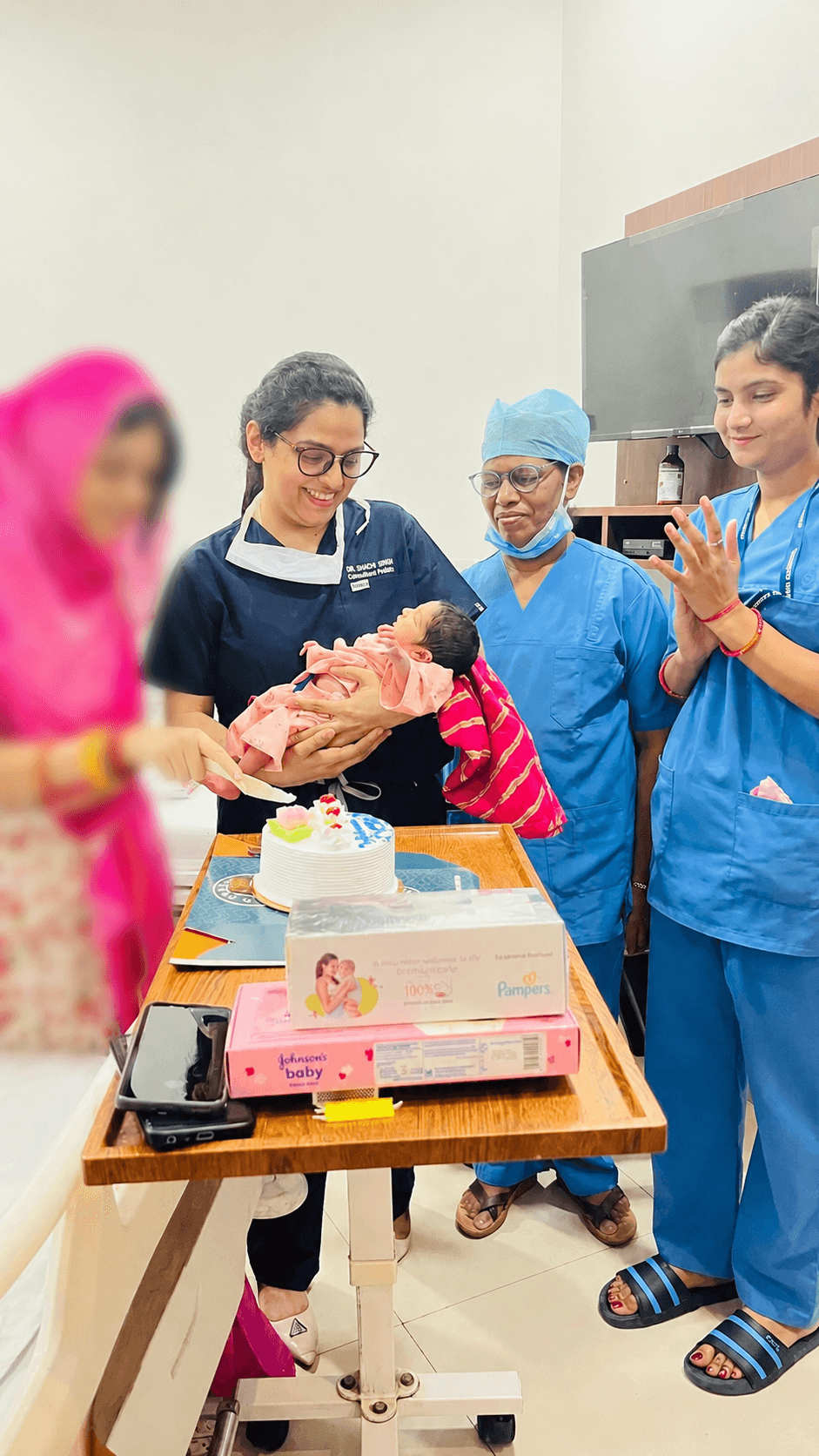 Dr. Shachi Singh celebrating a successful delivery with the mother and newborn at Prakash Hospital Noida