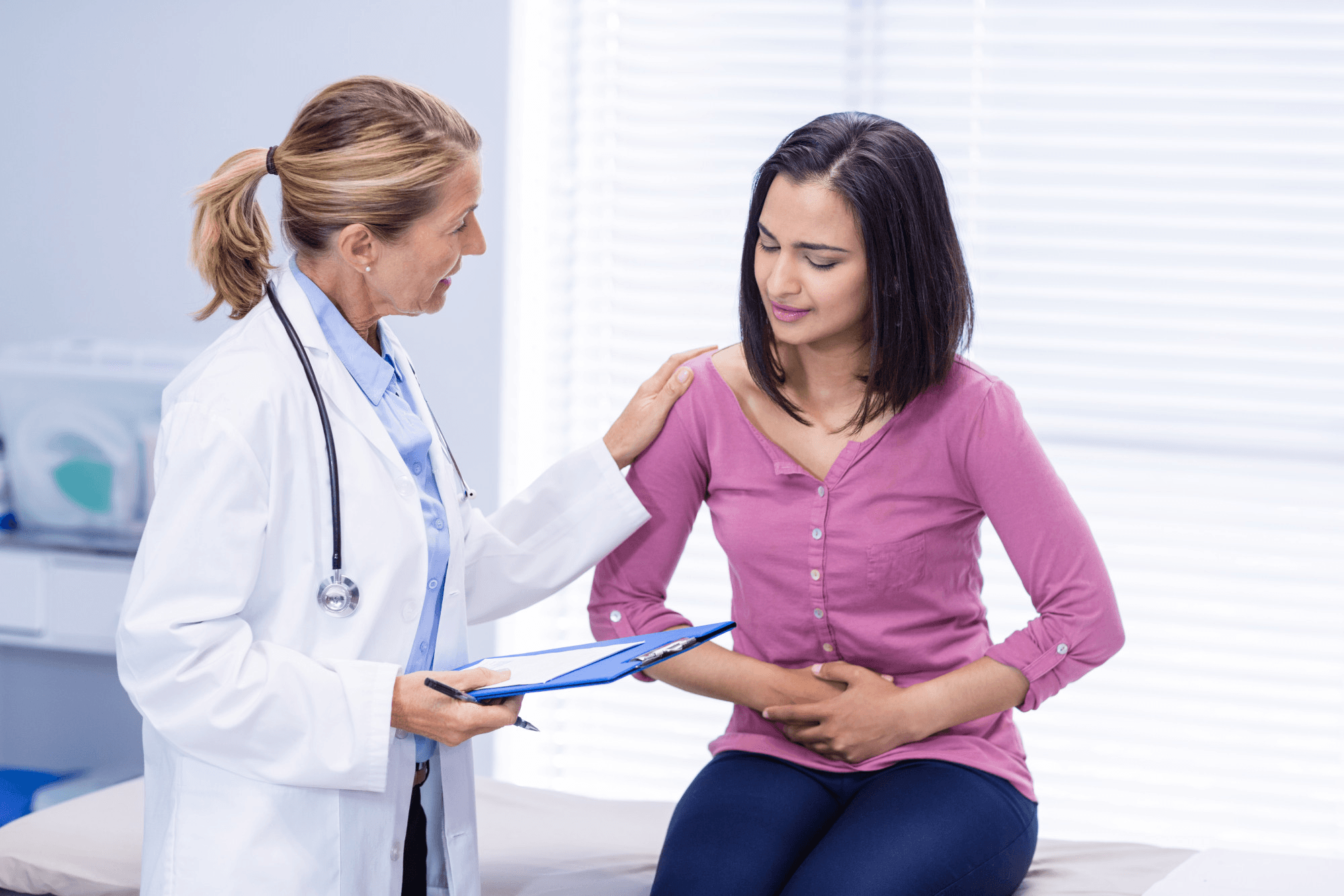 Woman consulting a gynecologist for menstrual pain and period-related problems during a clinical visit, discussing symptoms and treatment options.