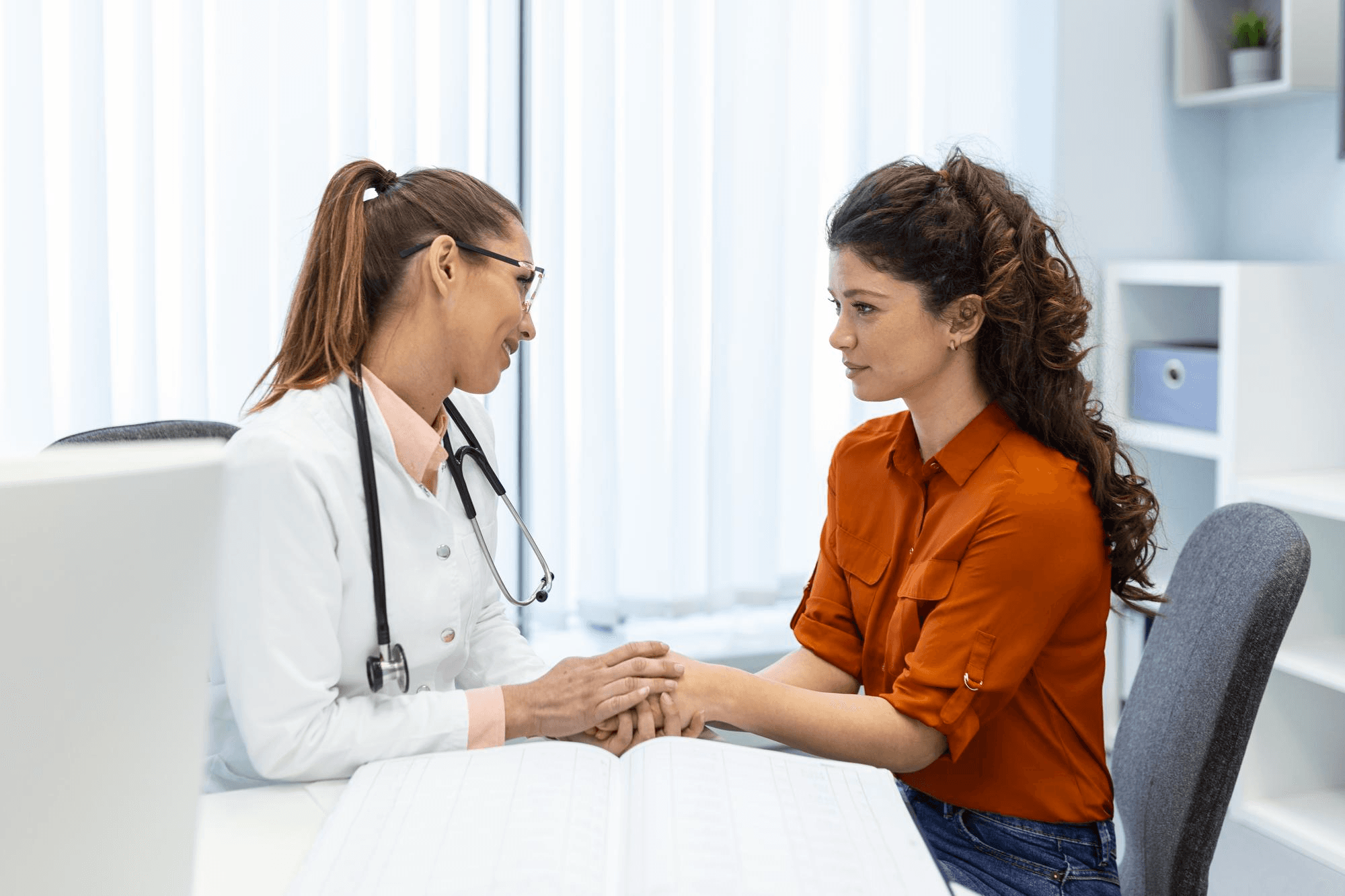 Woman consulting a gynecologist in a clinic for vaginal infection concerns, discussing symptoms and treatment during a supportive women's health medical appointment.