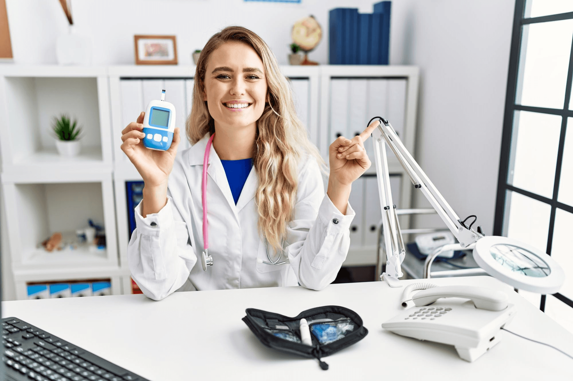 Doctor holding blood sugar testing device in hand.
