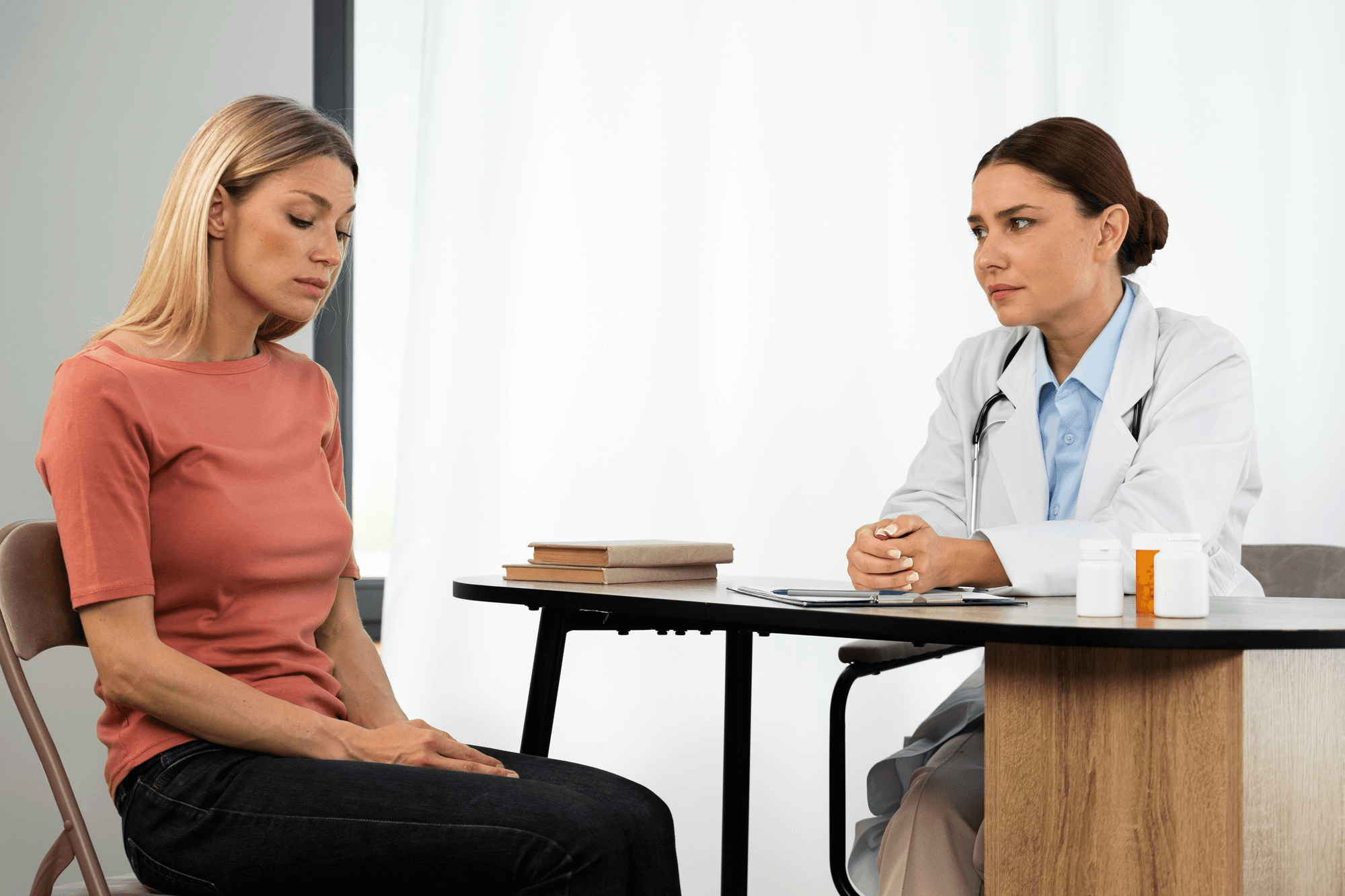 Woman and doctor discussing perimenopause symptoms, which include hot flashes, mood swings, and sleep problems.