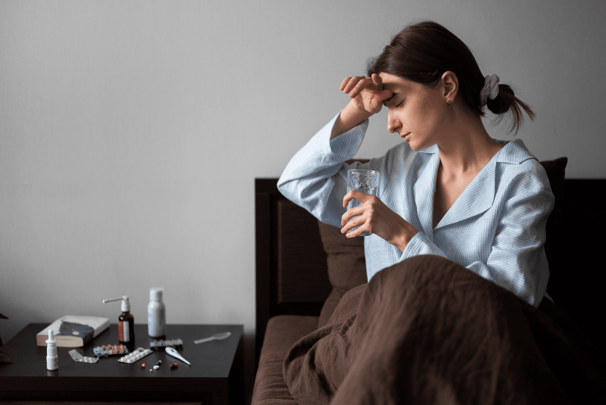 Pregnant woman with headaches, stress, with a glass of water, shows a hormonal imbalance leading to pregnancy hypertension