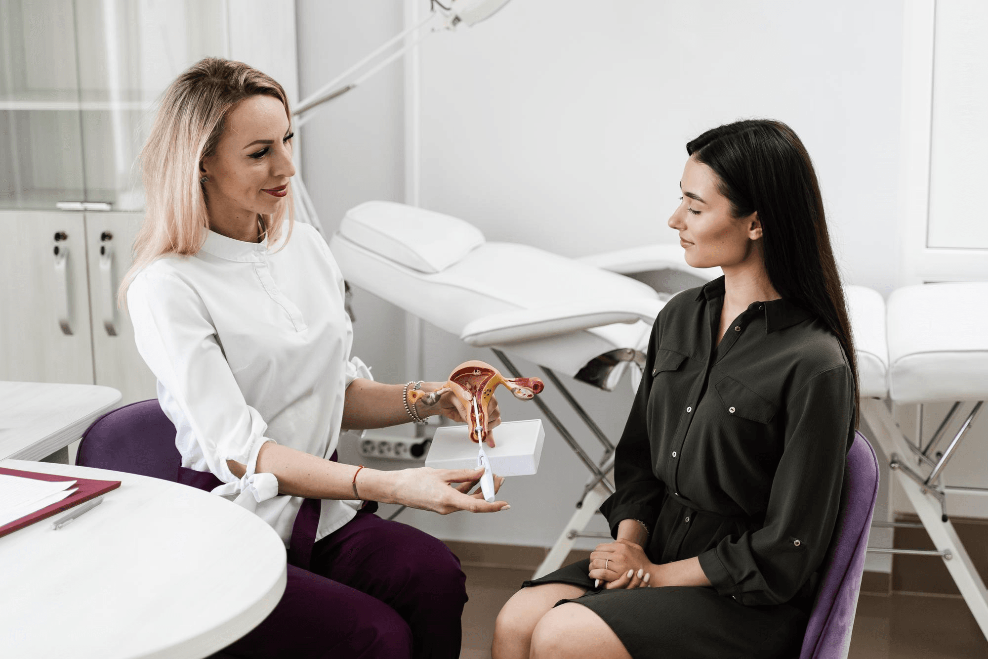A medical professional explains the female reproductive anatomy to a patient, discussing symptoms, diagnosis and treatments for vaginal infections.