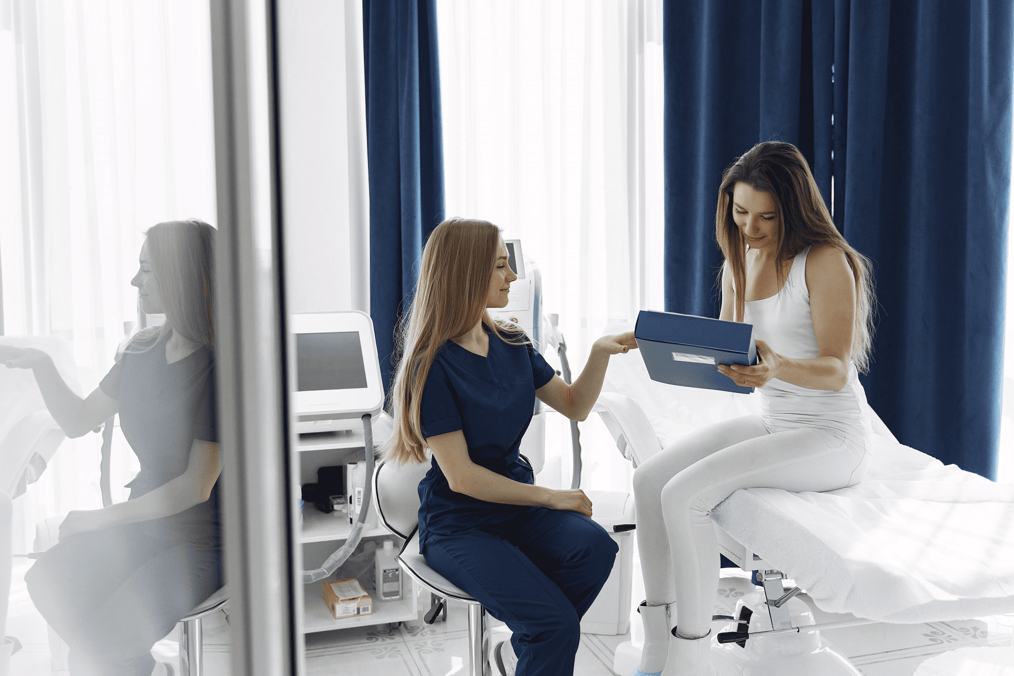 Doctor explaining to patient the clitoral hood reduction surgery, procedure benefits, risks, potential outcome and the options of care available.