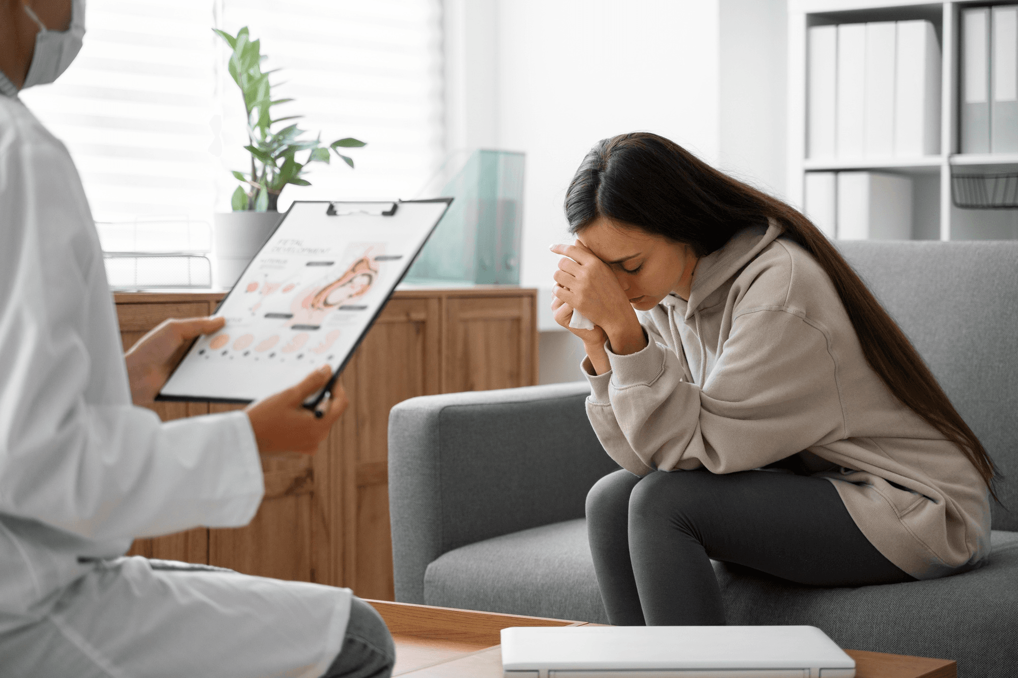 Woman confides in her doctor with deep grief and concern about her miscarriage