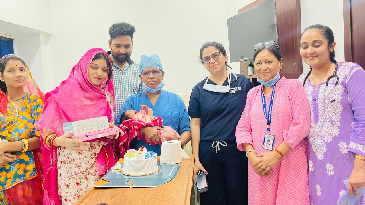 Family with their newborn baby alongside Dr. Shachi Singh and the Prakash Hospital medical team