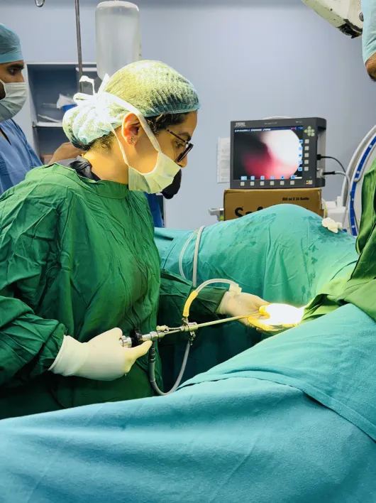 Close-up of laparoscopic surgical tools being used in a delicate procedure
